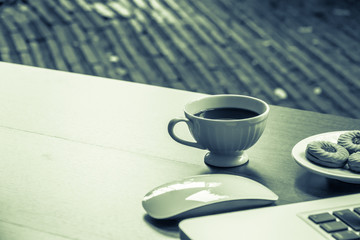 Top view home office table with laptop, coffee and cookie on wooden table. Modern office top view at home. New life style. Concept : business and office.