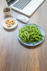 Top view home office table with laptop, coffee and cookie on wooden table. Modern office top view at home. New life style. Concept : business and office.