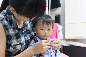 Asian cute baby is dressing up.