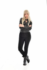 Fototapeta premium full length portrait of blonde girl wearing black leather outfit, standing pose on white background.
