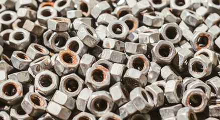 Old rusty metal nuts. Repair shop