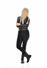 full length portrait of blonde girl wearing black leather outfit, standing pose on white background.