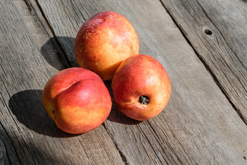 Fototapeta na wymiar fresh peaches on wood background