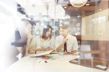 Obraz premium Team of young asian people discussing new business plan during a meeting in office.