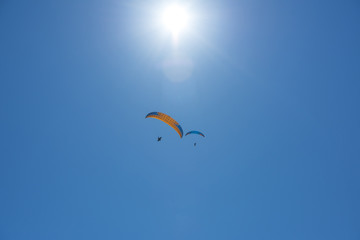 Skydiving flying under the sun. Parachute extreme sport