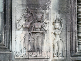 Apsara dancers stone carving all around on the wall at Angkor Wat Siem Reap Cambodia.