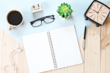 Business, weekend, holiday or new year planning concept : Top view or flat lay of open notebook paper, accessories, cube calendar and coffee cup on wooden background, ready for adding or mock up