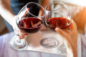 happy friends in a bar drinking red wine.