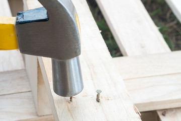 Hammer and Nail on wood.