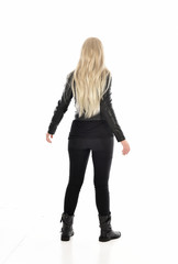 full length portrait of blonde girl wearing black leather outfit, standing pose on white background.
