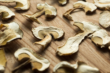 Dried mushrooms on a wooden table, non-traditional medicine and narcotic drugs.