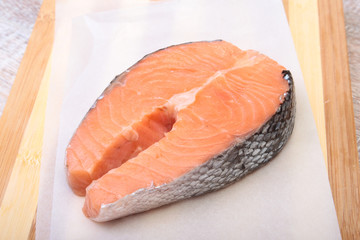 fresh raw salmon with spices on wooden cutting board. ready for cookin