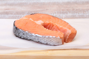 fresh raw salmon with spices on wooden cutting board. ready for cookin