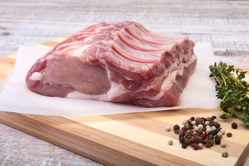 Raw pork chops, spices and rosemary on cutting board. Ready for cooking.