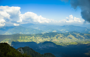 Fototapeta na wymiar mountain valley and clouds, summer landscape in Romanian Carpathians
