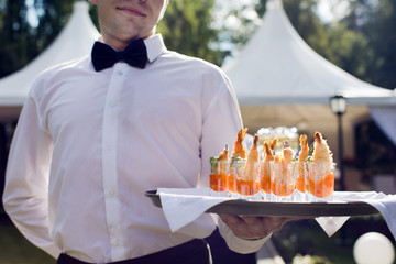 Waiter walking with appetizers