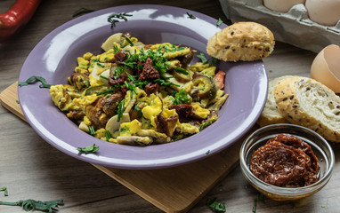 Scrambled egg with dried tomatoes and home baked goods