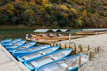 Fototapeta na wymiar Boats with fall colors, Arashiyama