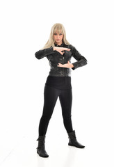 Fototapeta premium full length portrait of blonde girl wearing black leather outfit, standing pose on white background.