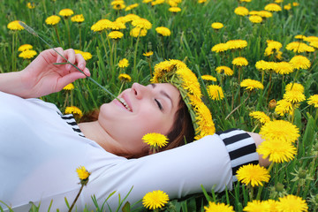 woman on ground dandelion meadow