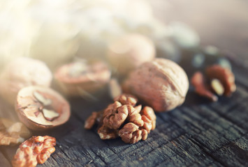 walnuts, whole and peeled wooden background