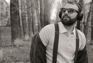 monochrome beard man listen music in park