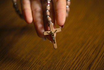 Woman Praying With Rosary Beads In Hand