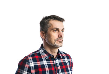 Mature hipster man in checked shirt. Studio shot, isolated.