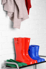 Different shoes on shelf near wall