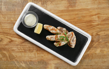 Fototapeta na wymiar Slate plate with delicious squids on table