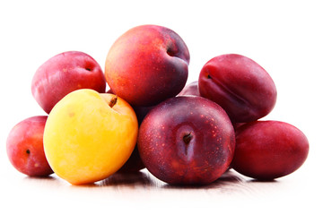 Composition with plums isolated on white background
