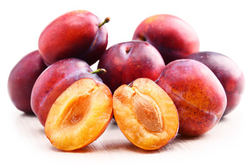 Composition with plums isolated on white background