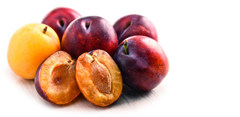Composition with plums isolated on white background