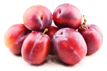 Composition with plums isolated on white background