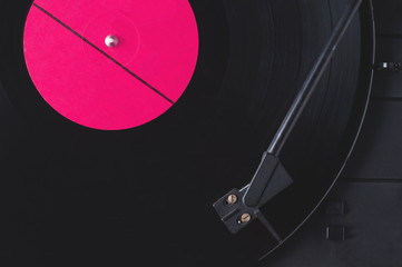 Vinyl record with red label and old player