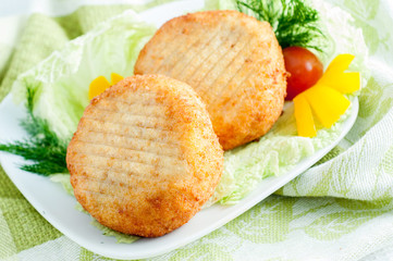 Beef cutlets with greens and vegetables on the plate