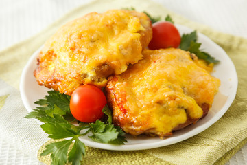 Meat cutlet steak under cheese with greens