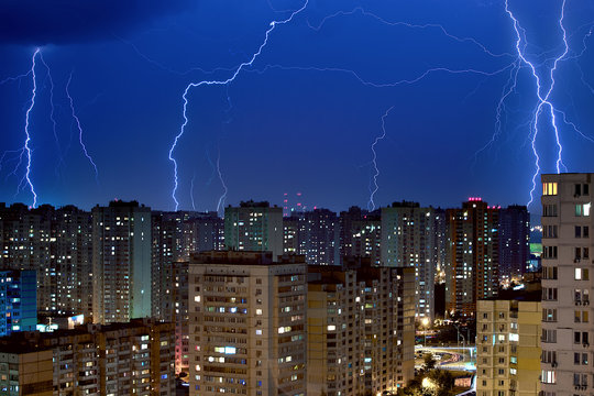 Large lightning bolts above the city.