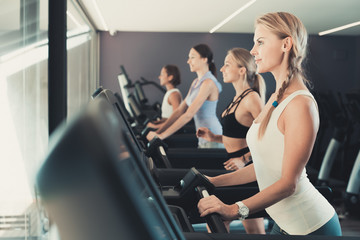 Fototapeta na wymiar Women running on treadmills