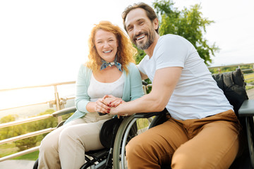 Joyful disabled couple resting in the park
