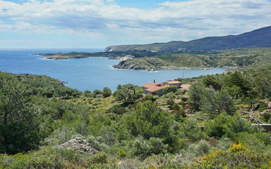 Fototapeta na wymiar Spain Costa Brava rocky coastal landscape with an house near Cadaques, Guillola bay, Mediterranean sea, Cap de Creus, Catalonia