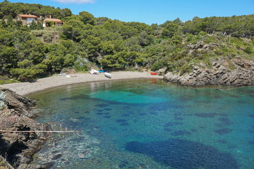 Fototapeta na wymiar Spain Costa Brava peaceful pebble beach of the Mediterranean sea, Cala Guillola, Cadaques, Cap de Creus, Catalonia