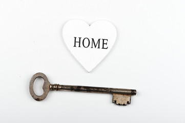 Top view of a white heart next to a wrench on white background. Isolated. Copy space.