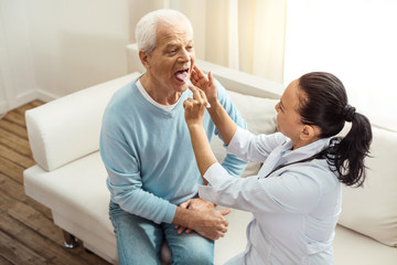 Pleasant elderly man doing a medical checkup