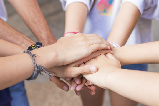 group of friends hands stacked and together, union and friendship
