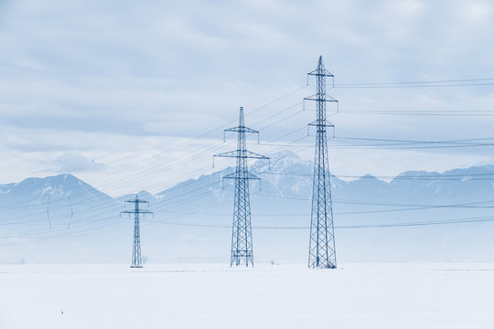 Electric pylons in the snow field
