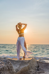 Fototapeta na wymiar Classy woman on the beach in Greece