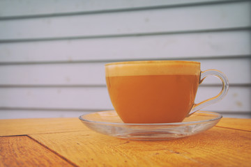 image of coffee cup over old wooden table