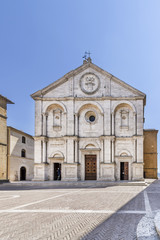 Fototapeta na wymiar The stunning facade of the Duomo di Santa Maria Assunta cathedral, Pio II square, in the historic center of Pienza, Siena, Italy on a sunny day