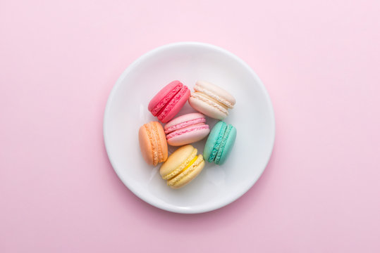 Colorful pastel cake macaron or macaroon on plate.